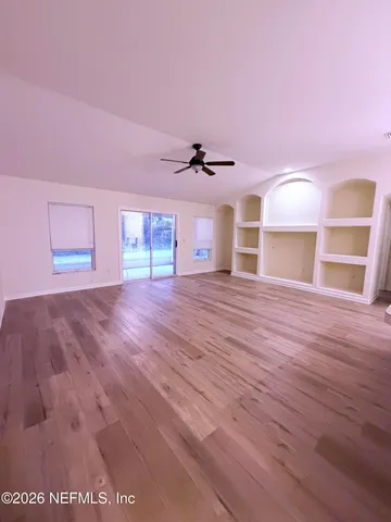 a view of a livingroom with a ceiling fan and window