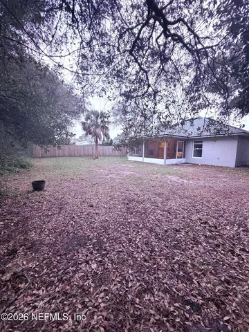 an outdoor view of house with yard and trees