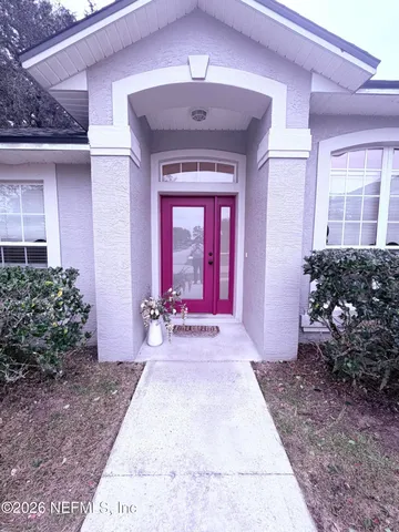 a view of a house with potted plants