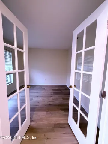a view of walk in closet with empty racks