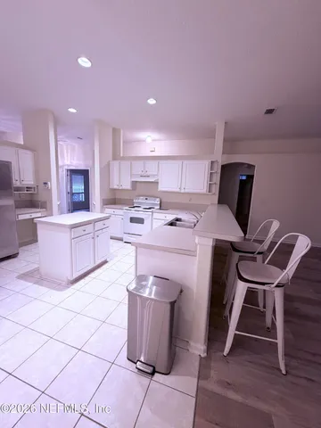 a kitchen with a sink a table and chairs