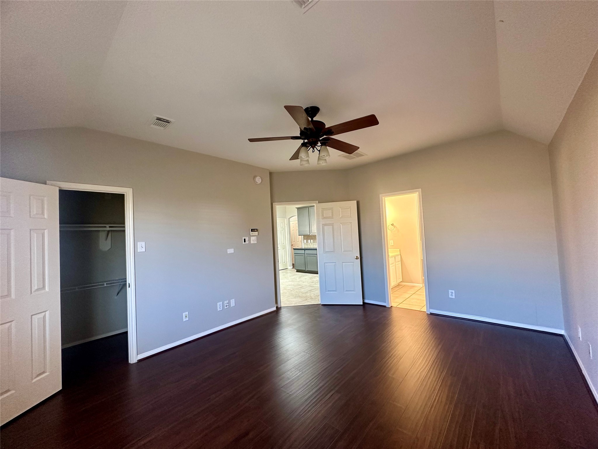 18822 Appletree Ridge Road Houston, TX 77084 - Photo 18 of 27 a view of an empty room with wooden floor and a ceiling fan