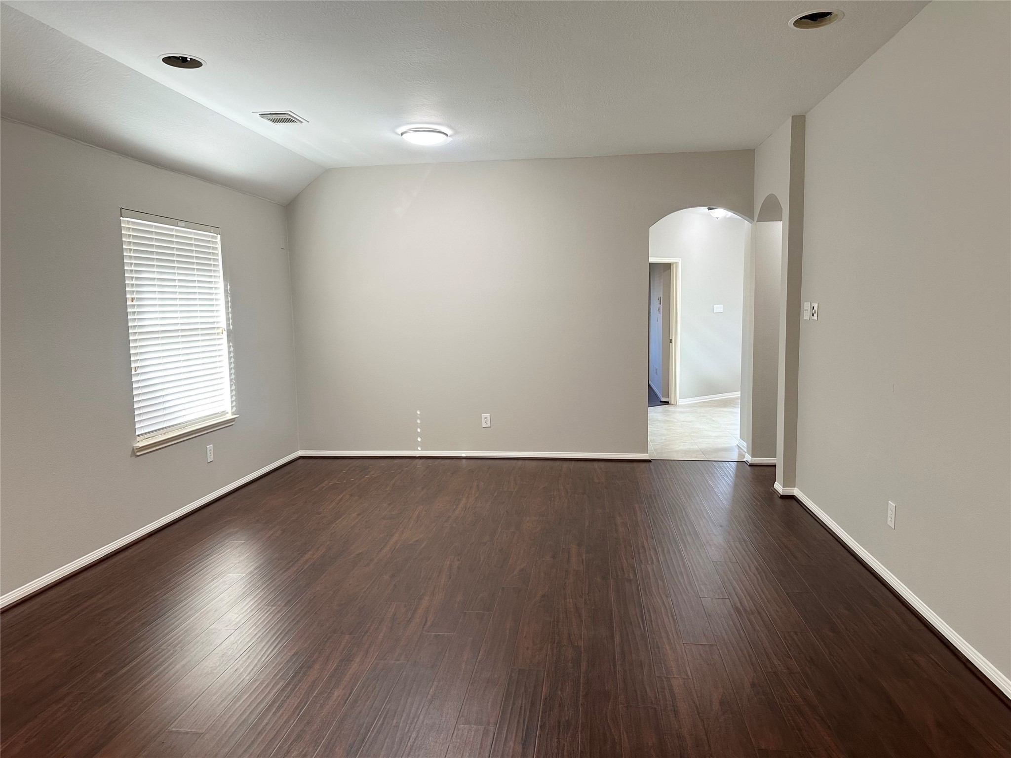 18822 Appletree Ridge Road Houston, TX 77084 - Photo 3 of 27 an empty room with wooden floor and windows