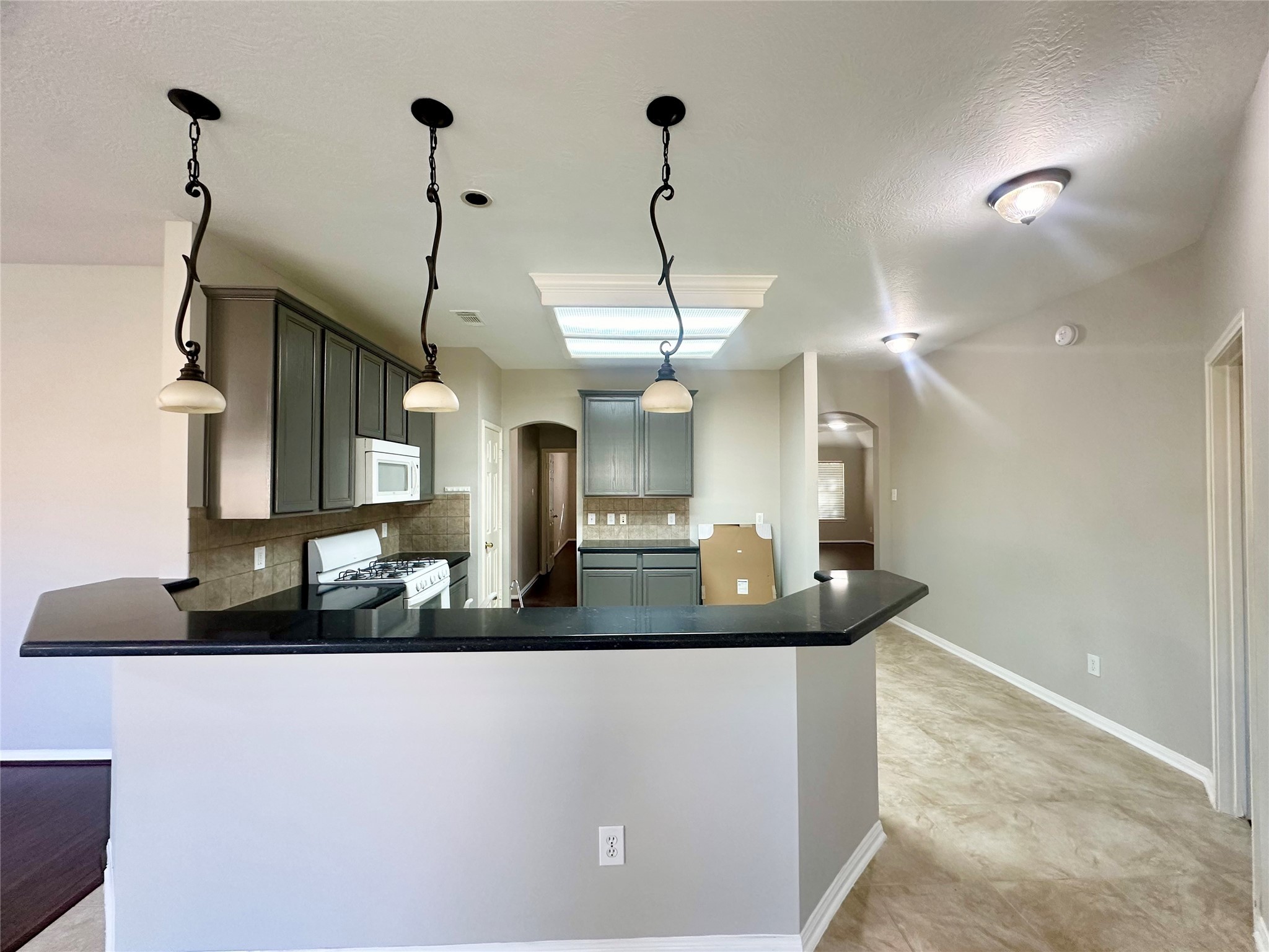 18822 Appletree Ridge Road Houston, TX 77084 - Photo 5 of 27 a kitchen with a counter top space appliances and a chandelier