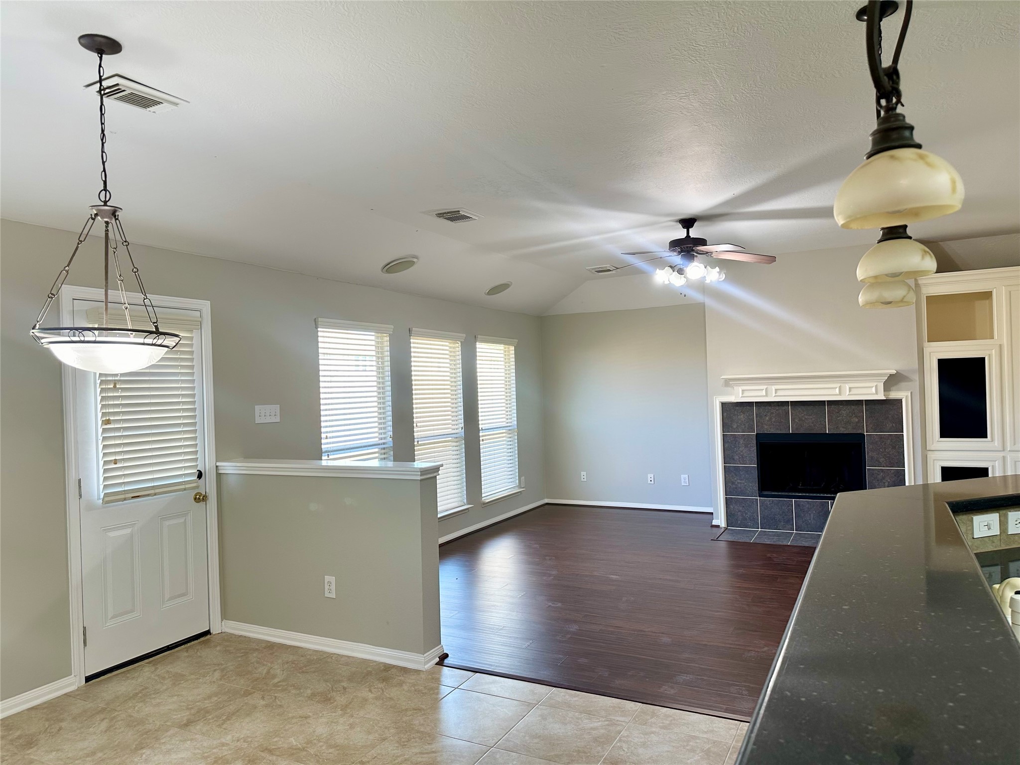 18822 Appletree Ridge Road Houston, TX 77084 - Photo 8 of 27 a view of a livingroom with a fireplace a ceiling fan and windows