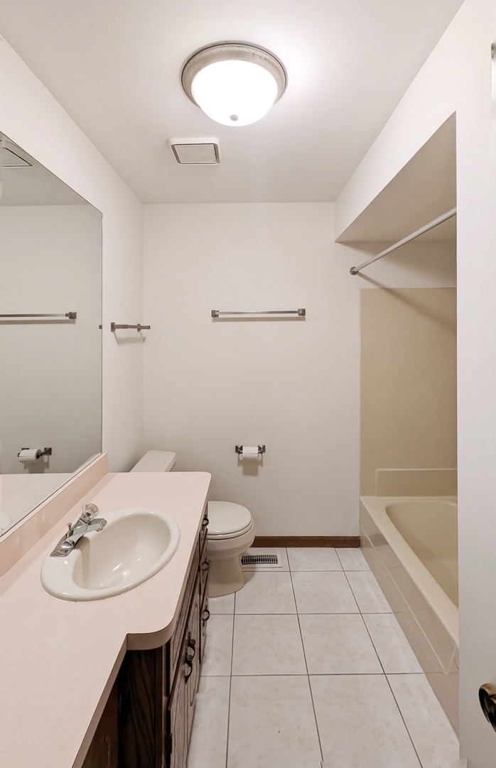 600 Crescenzo Court, Unit B New Lenox, IL 60451 - Photo 6 of 13 a bathroom with a sink a toilet and a mirror