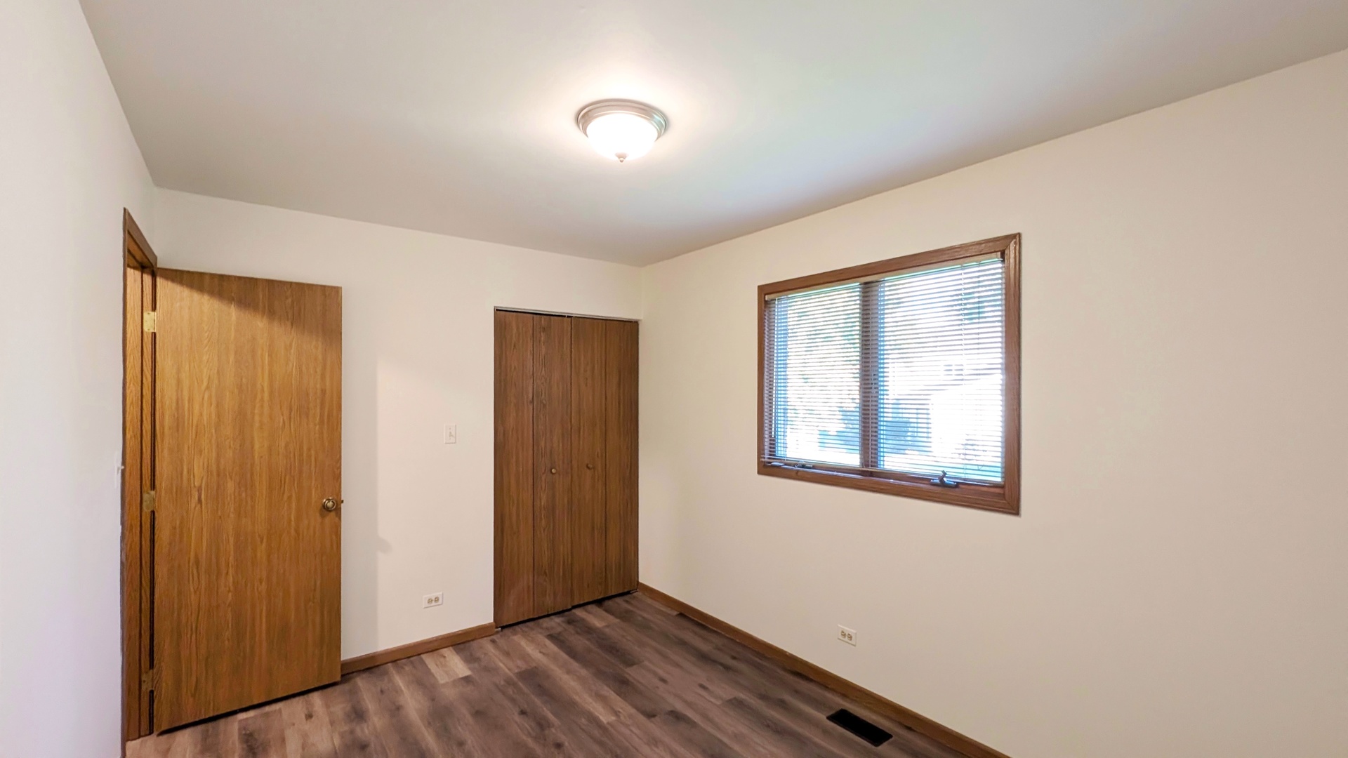 600 Crescenzo Court, Unit B New Lenox, IL 60451 - Photo 7 of 13 a view of an empty room with wooden floor and a window