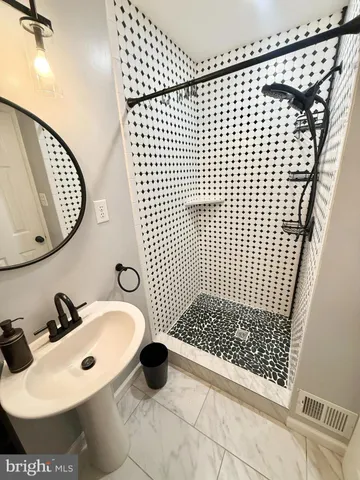 a bathroom with a sink toilet and mirror