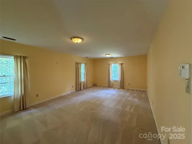 a view of empty room with windows