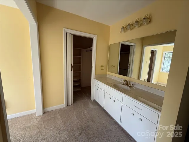 a bathroom with a double vanity sink and mirror