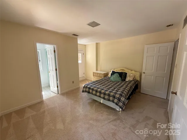 a bedroom with a bed and cabinets