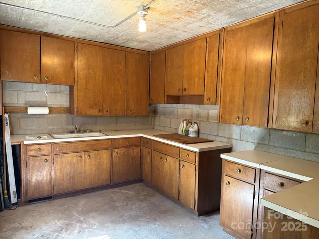 a kitchen with a sink cabinets and window