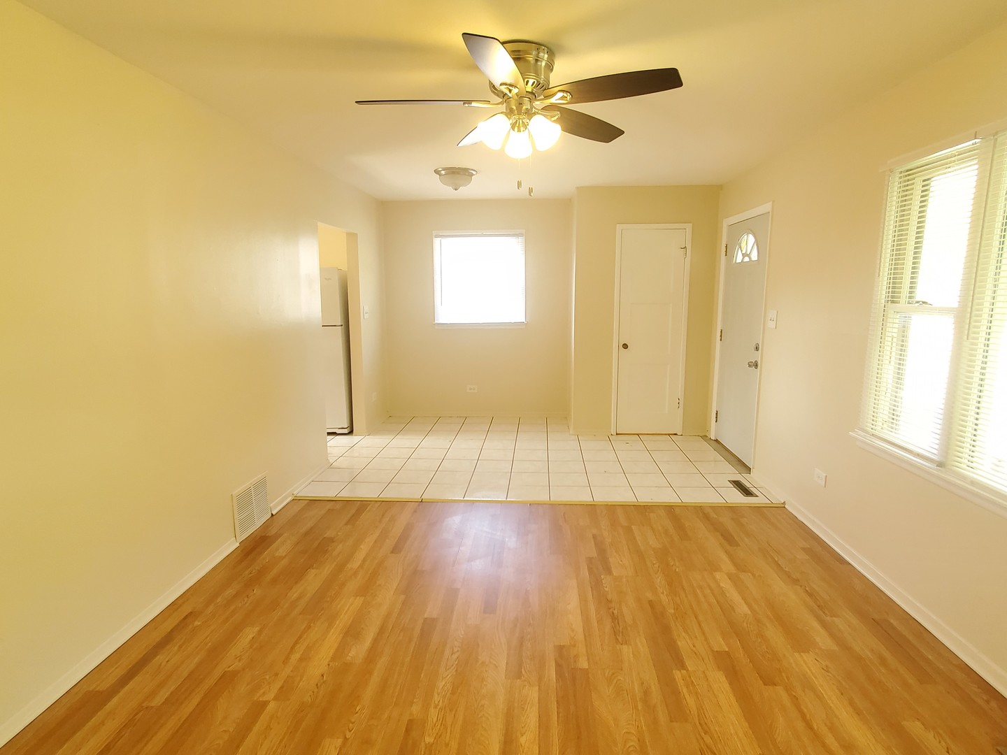 1657 Rice Street Waukegan, IL 60087 - Photo 4 of 10 a view of a room with wooden floor and a ceiling fan