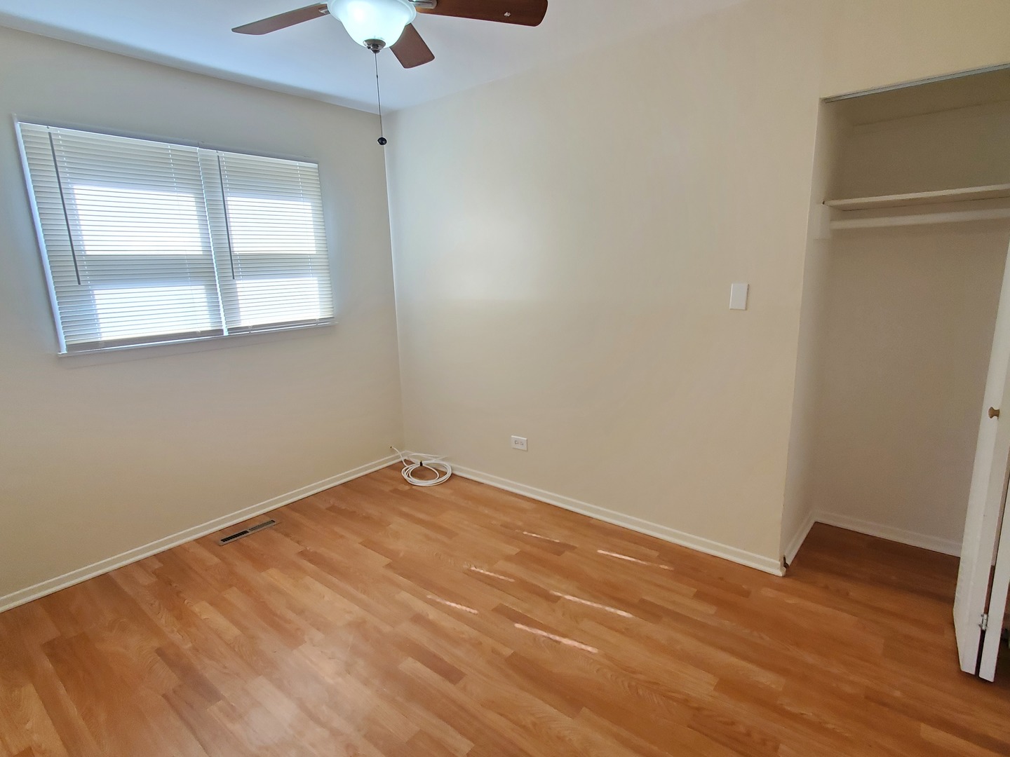 1657 Rice Street Waukegan, IL 60087 - Photo 6 of 10 wooden floor in an empty room with a window