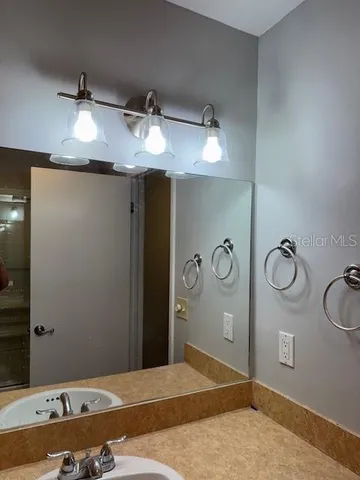 a bathroom with a sink and a mirror