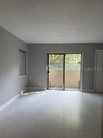 an empty room with a sliding door and glass door