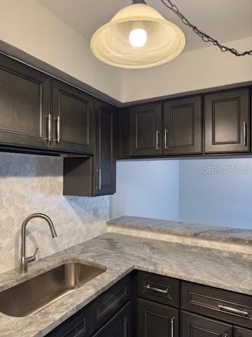 a kitchen with a sink and cabinets