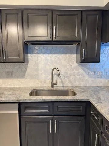 a kitchen with a sink and cabinets