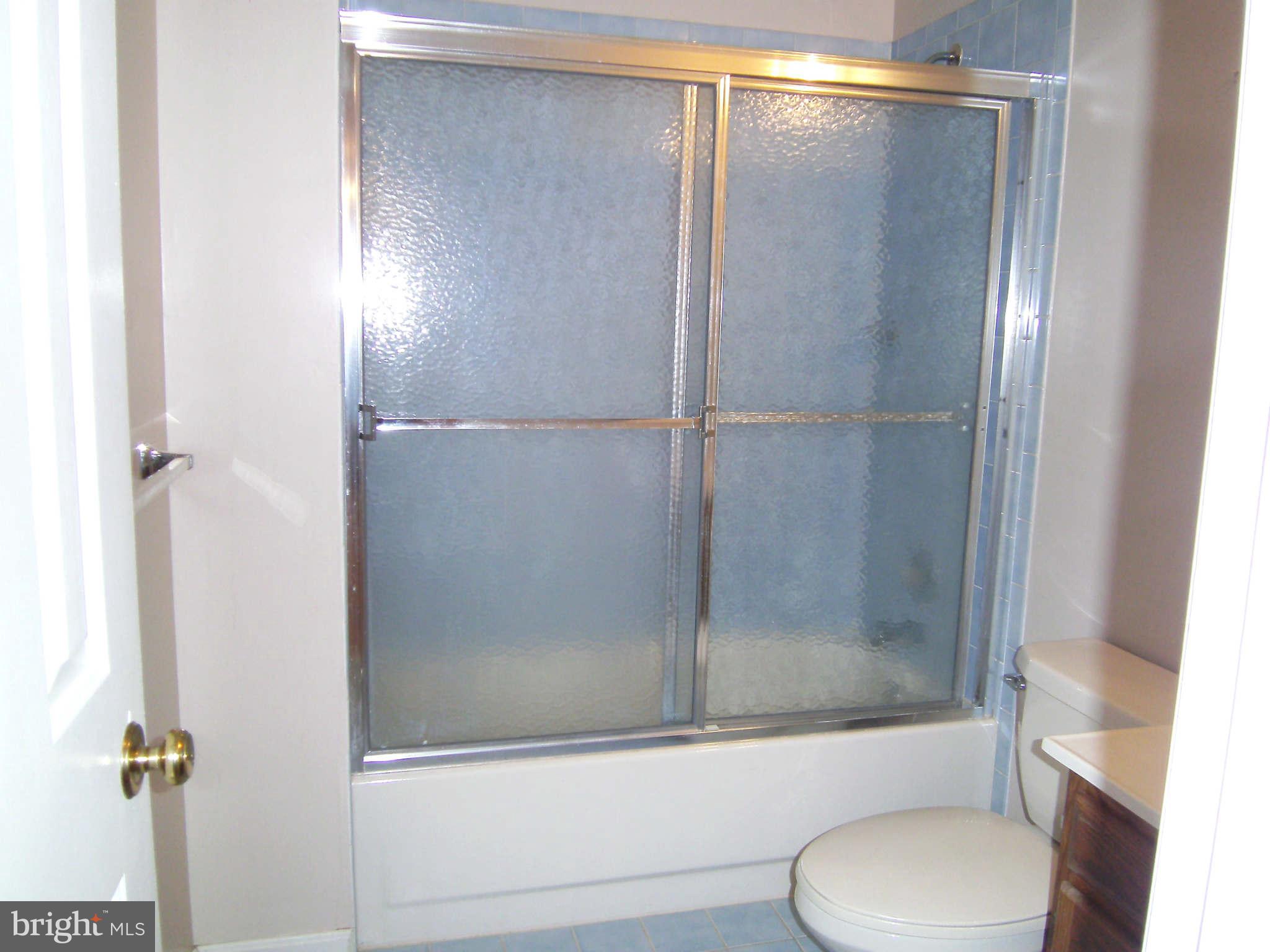 8662 Center Road Springfield, VA 22152 - Photo 17 of 23 a bathroom with a shower and a toilet