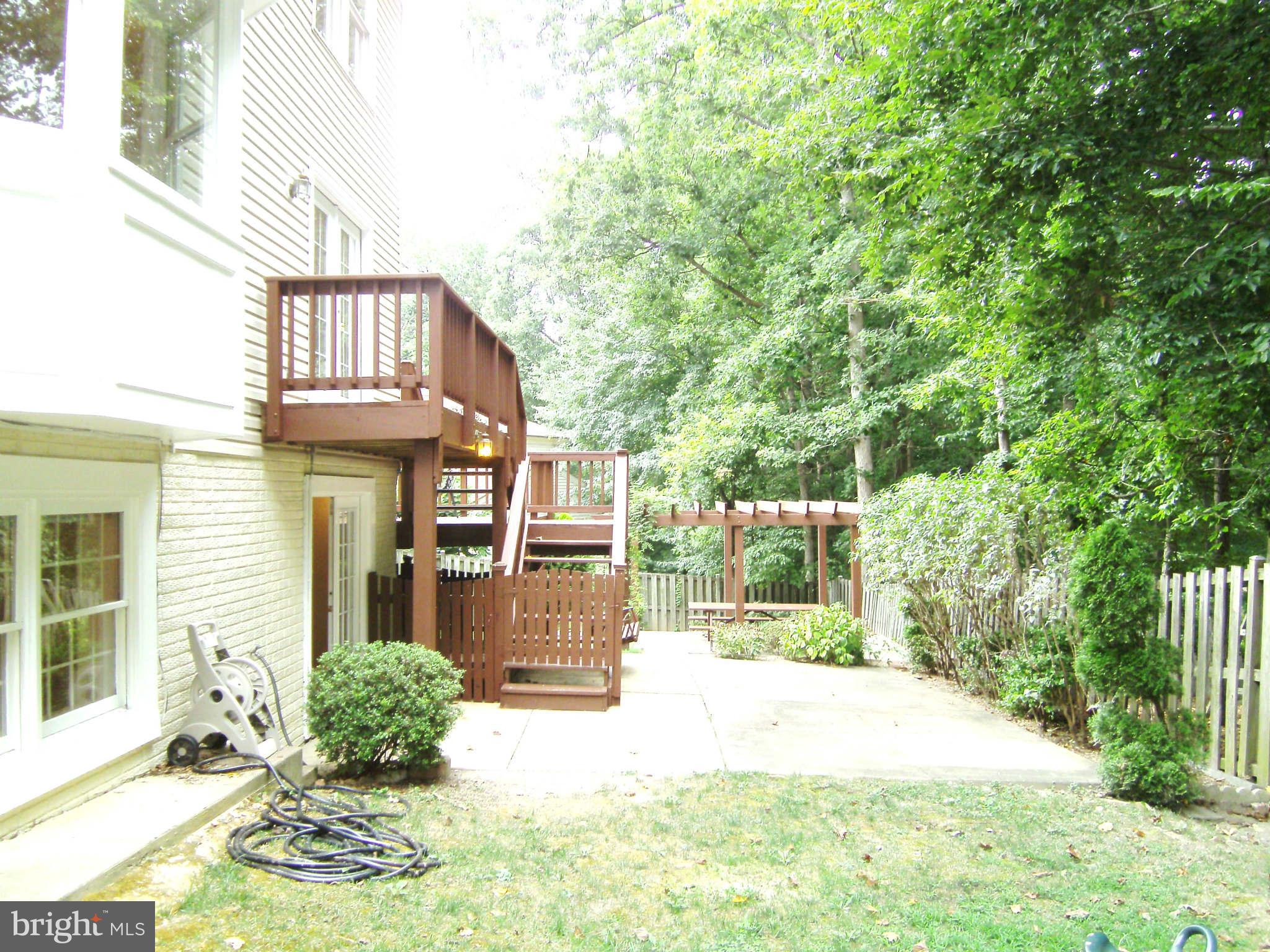 8662 Center Road Springfield, VA 22152 - Photo 20 of 23 a view of a house with backyard and sitting area