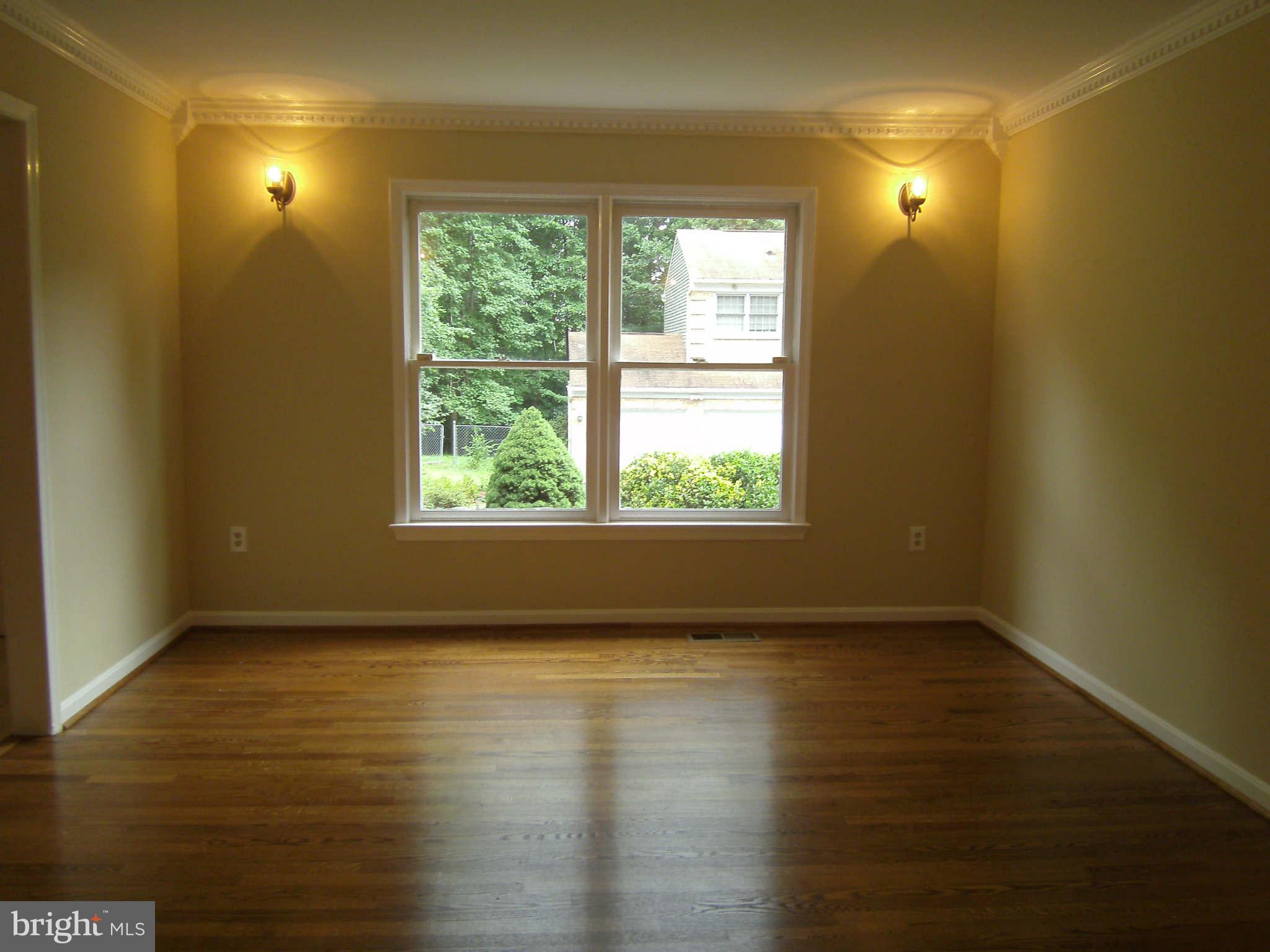 8662 Center Road Springfield, VA 22152 - Photo 3 of 23 a view of an empty room with wooden floor and a window