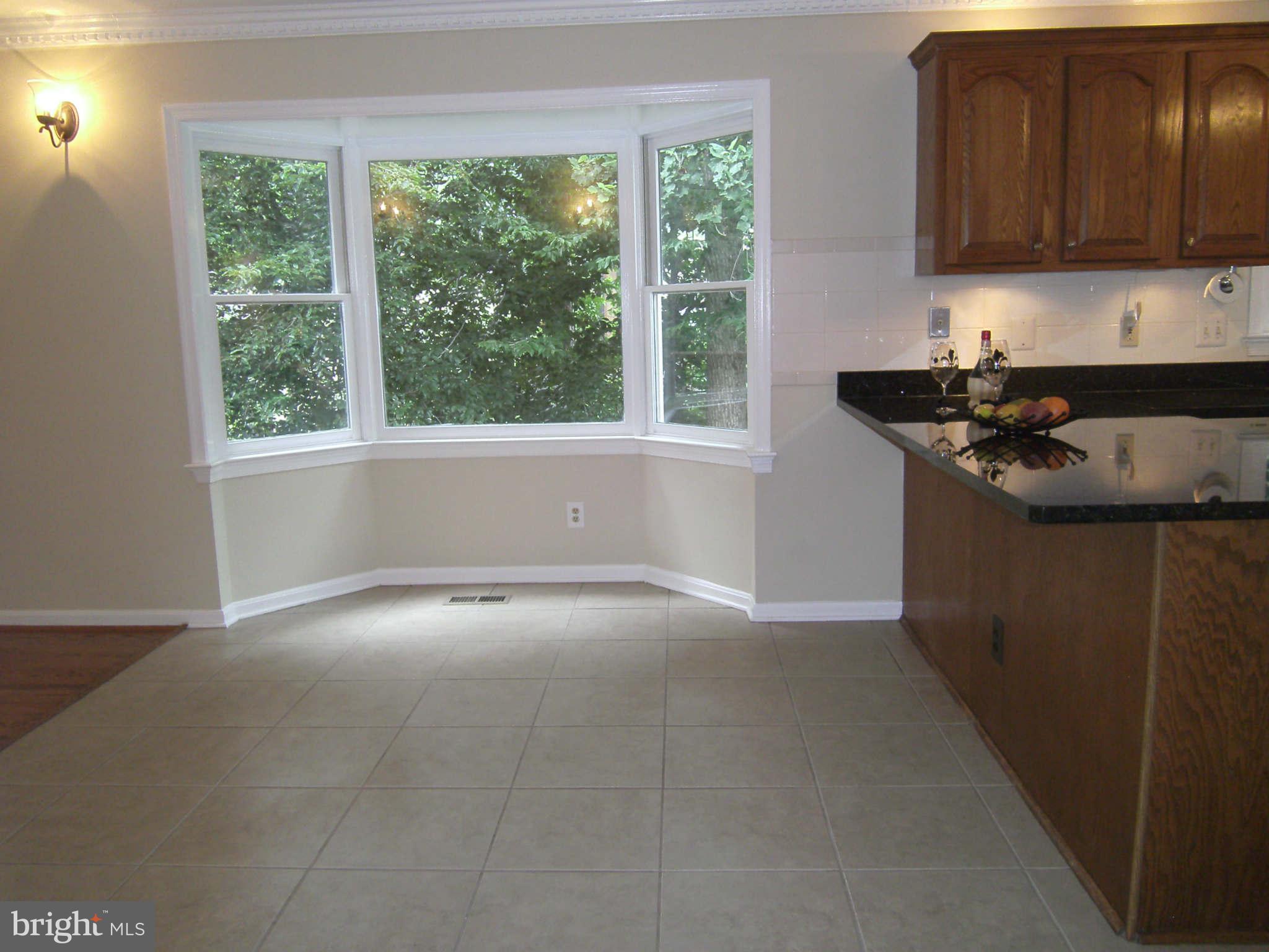 8662 Center Road Springfield, VA 22152 - Photo 6 of 23 a kitchen with stainless steel appliances granite countertop a sink stove and cabinets