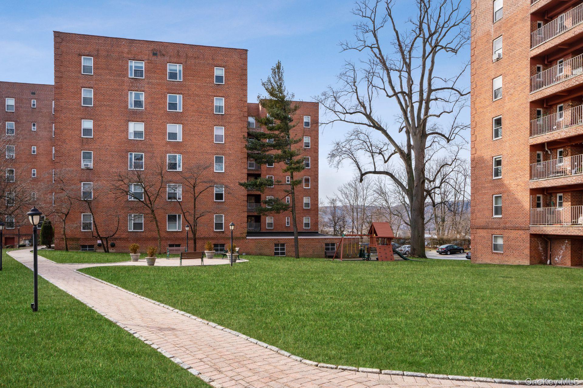 565 Broadway, Unit 1F Hastings-on-Hudson, NY 10706 - Photo 15 of 17 a view of a building with a yard