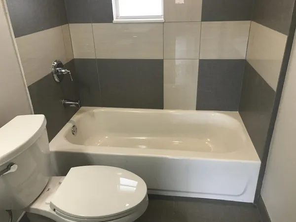 a bathroom with a toilet a sink and bathtub