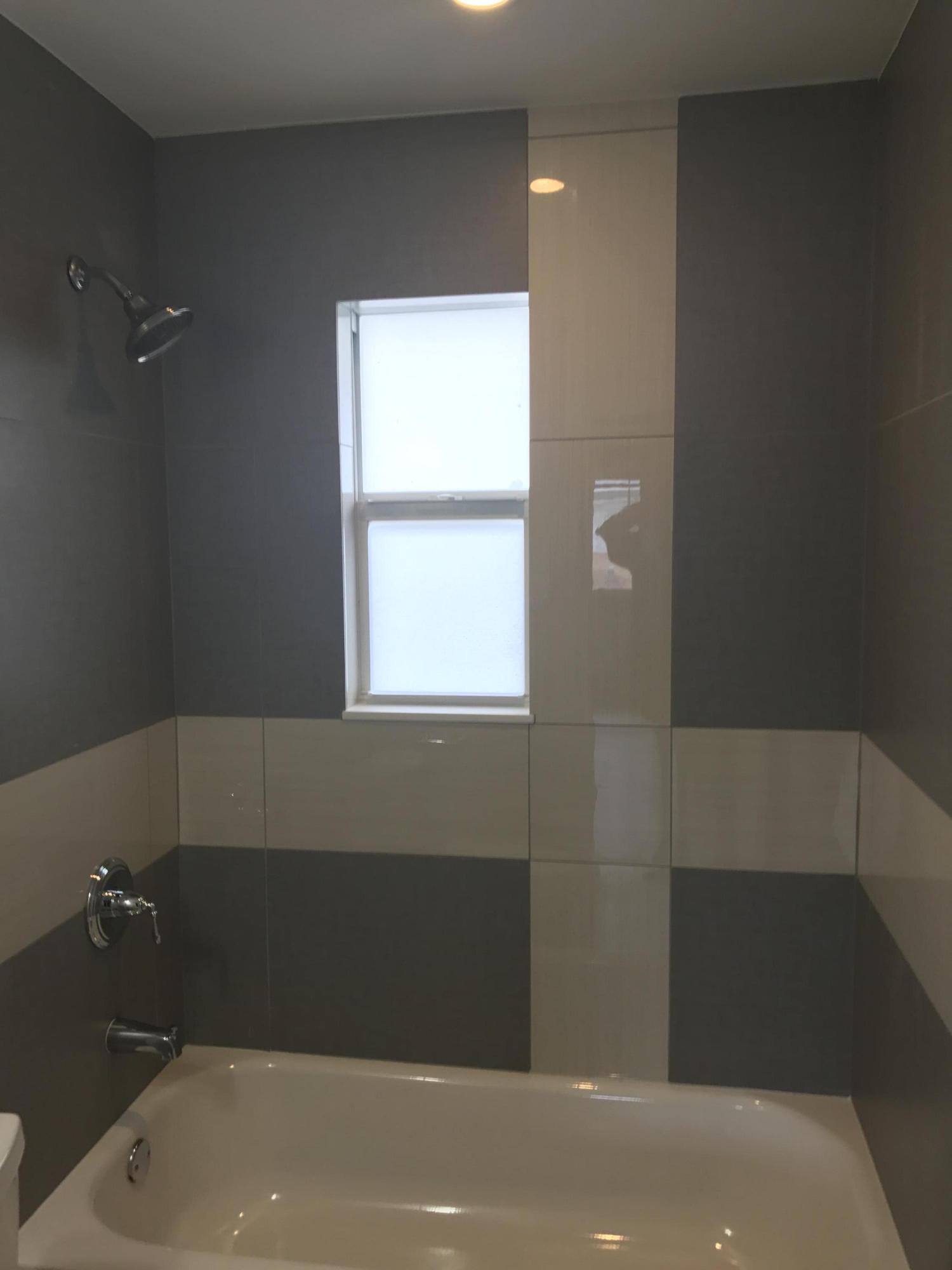 142 Southwest 8th Avenue, Unit B Delray Beach, FL 33444 - Photo 12 of 29 a bathroom with a bathtub