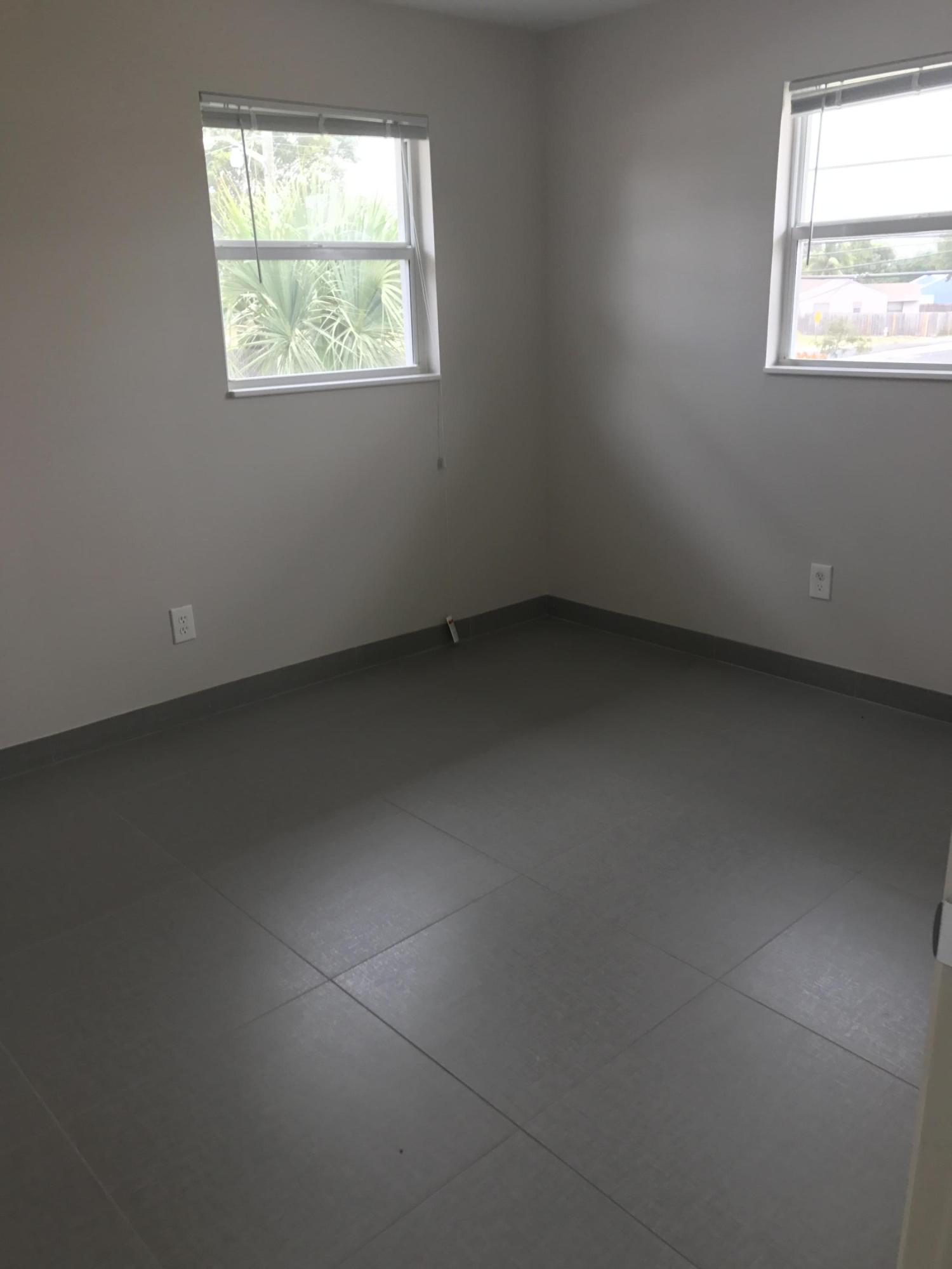 142 Southwest 8th Avenue, Unit B Delray Beach, FL 33444 - Photo 13 of 29 an empty room with a window