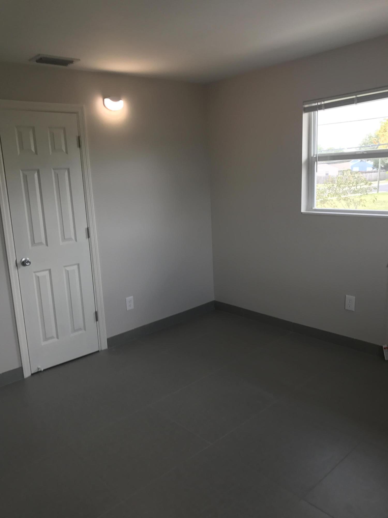 142 Southwest 8th Avenue, Unit B Delray Beach, FL 33444 - Photo 16 of 29 an empty room with a window