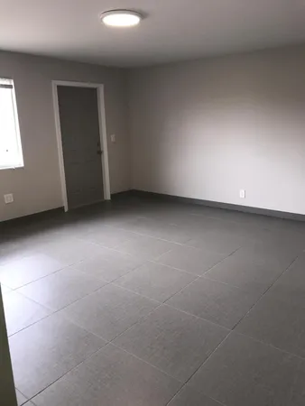 a front view of a house with a garden and parking