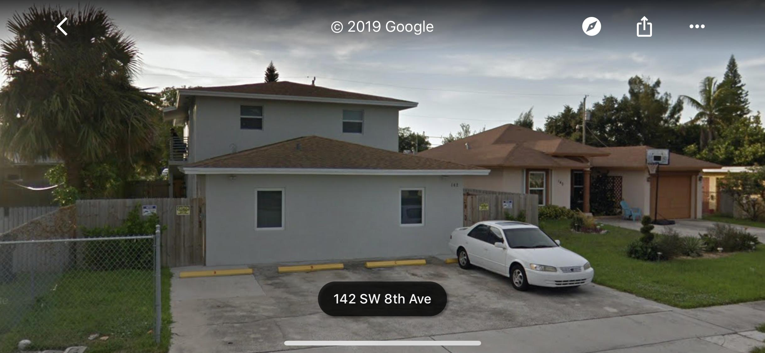 142 Southwest 8th Avenue, Unit B Delray Beach, FL 33444 - Photo 29 of 29 a front view of a house with a garden and parking