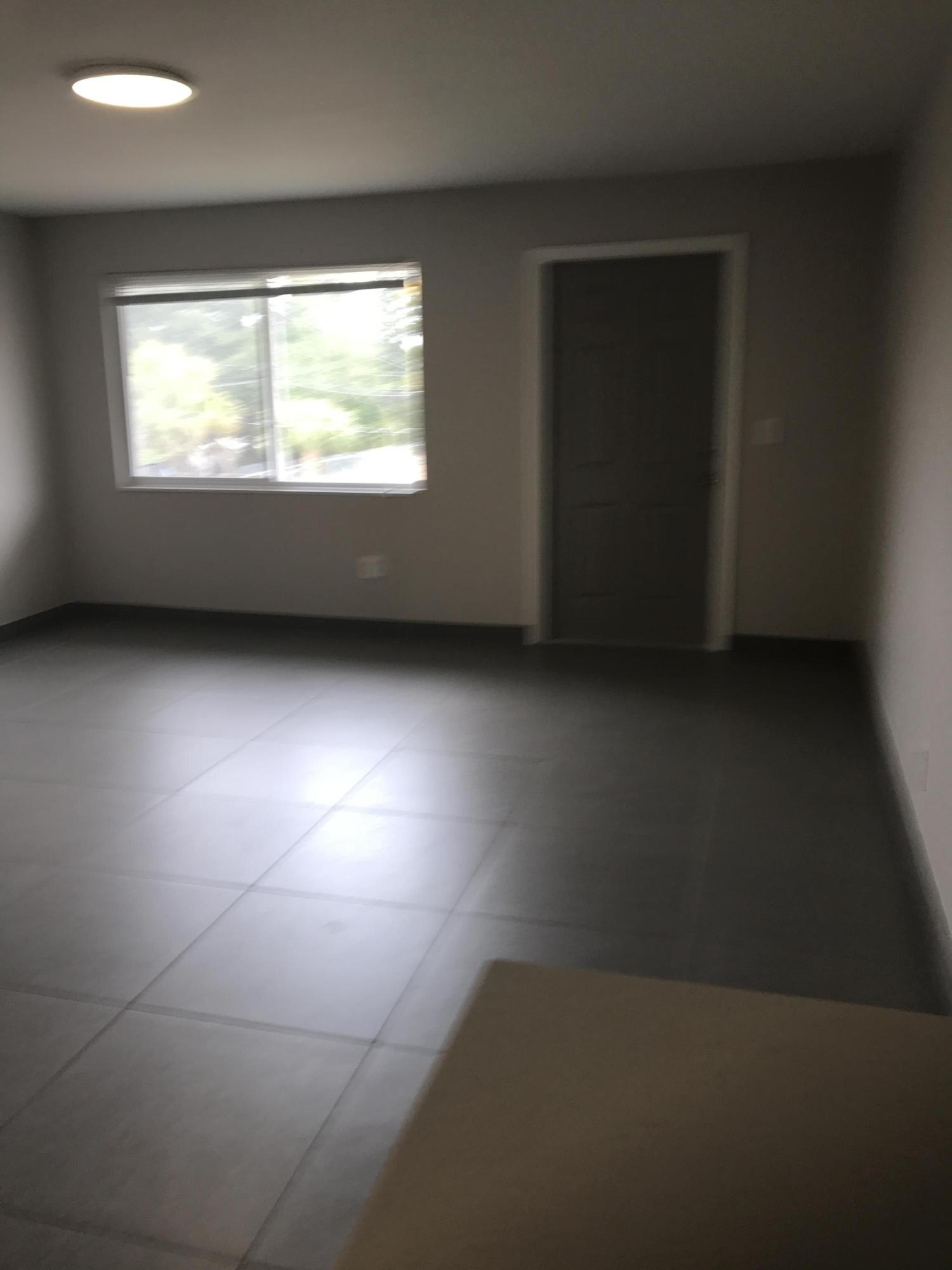 142 Southwest 8th Avenue, Unit B Delray Beach, FL 33444 - Photo 6 of 29 an empty room with a window