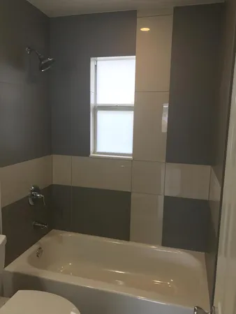 a bathroom with a bathtub and window