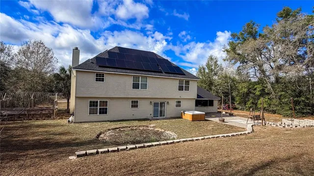 a kitchen with stainless steel appliances kitchen island granite countertop a sink a stove a dining table and chairs