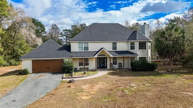 a backyard of a house with table and chairs