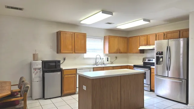 a kitchen with a sink a refrigerator a stove and a refrigerator
