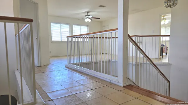 a view of staircase with railing and white walls
