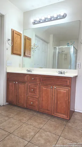 a spacious bathroom with a granite countertop sink and a mirror