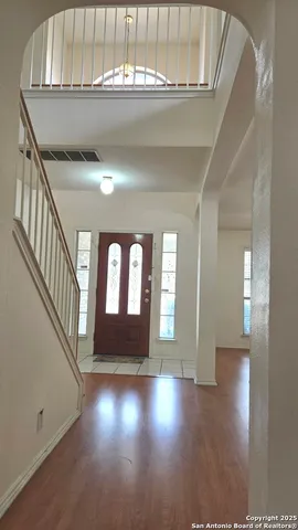 a view of an entryway with wooden floor