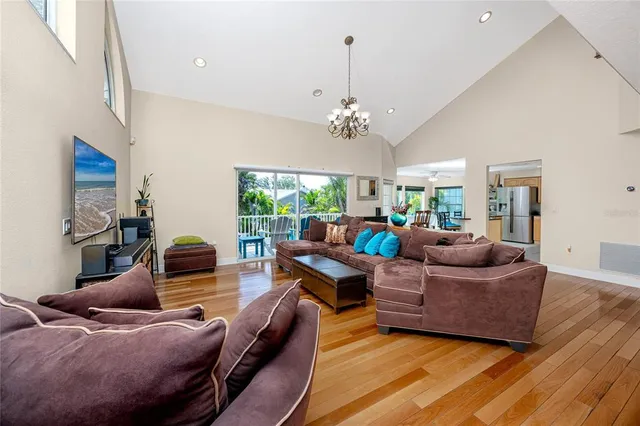 a kitchen with stainless steel appliances kitchen island granite countertop a table chairs sink and cabinets
