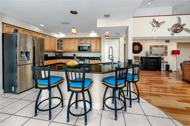 a view of a balcony with chairs and a potted plant