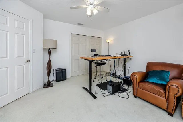 a view of a porch with furniture and floor to ceiling window