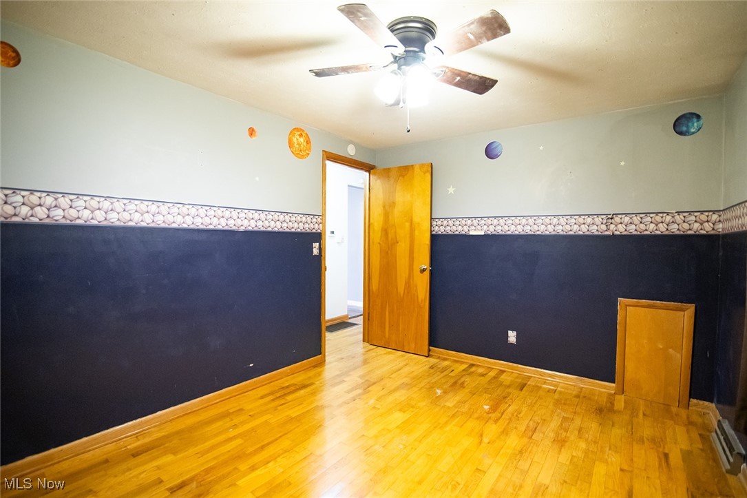 91 Mike Street Washington, WV 26181 - Photo 24 of 42 Spare room with wood finished floors and a ceiling fan
