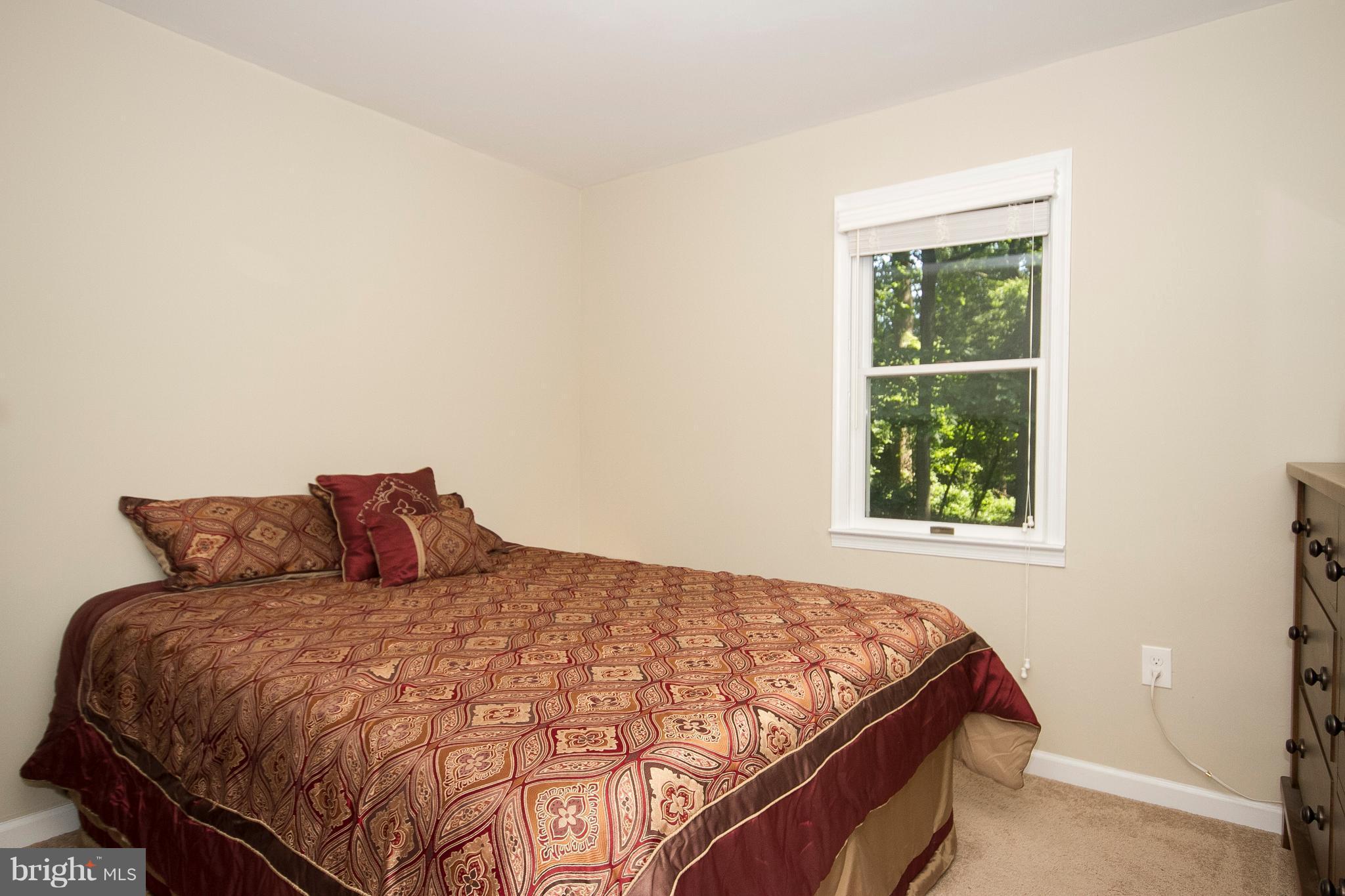 1618 Providence Road Towson, MD 21286 - Photo 15 of 30 a bed sitting in a bedroom next to a window