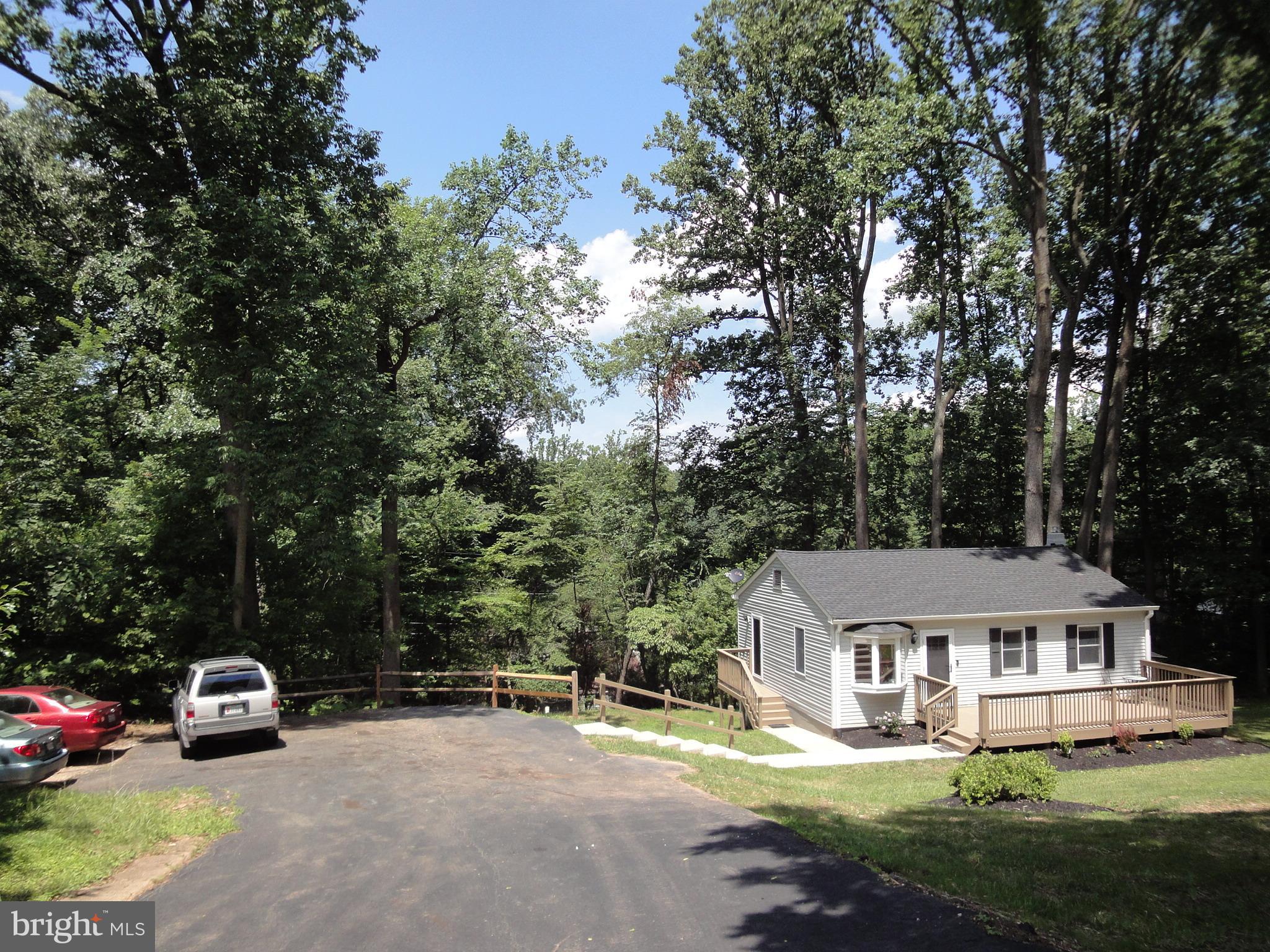 1618 Providence Road Towson, MD 21286 - Photo 3 of 30 an outdoor view of a house with a garden and trees