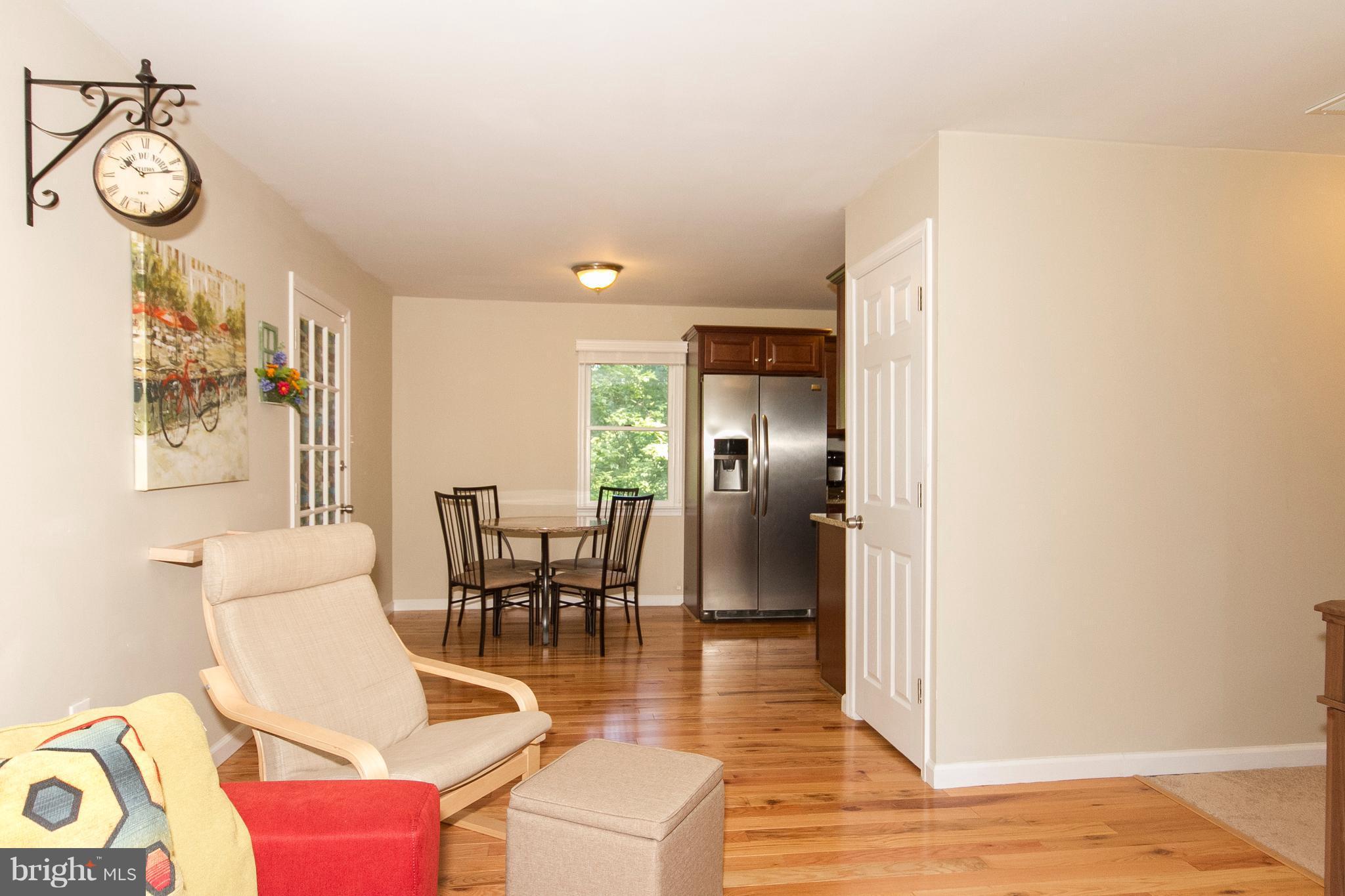 1618 Providence Road Towson, MD 21286 - Photo 10 of 30 a dining room with wooden floor a chandelier a wooden table and chairs