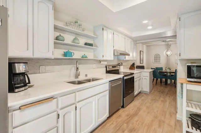 a kitchen with a sink window and cabinets