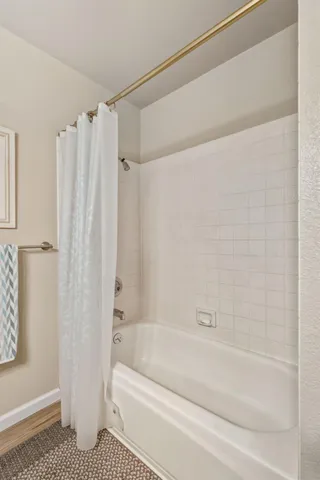 a bathroom with a bathtub and a shower